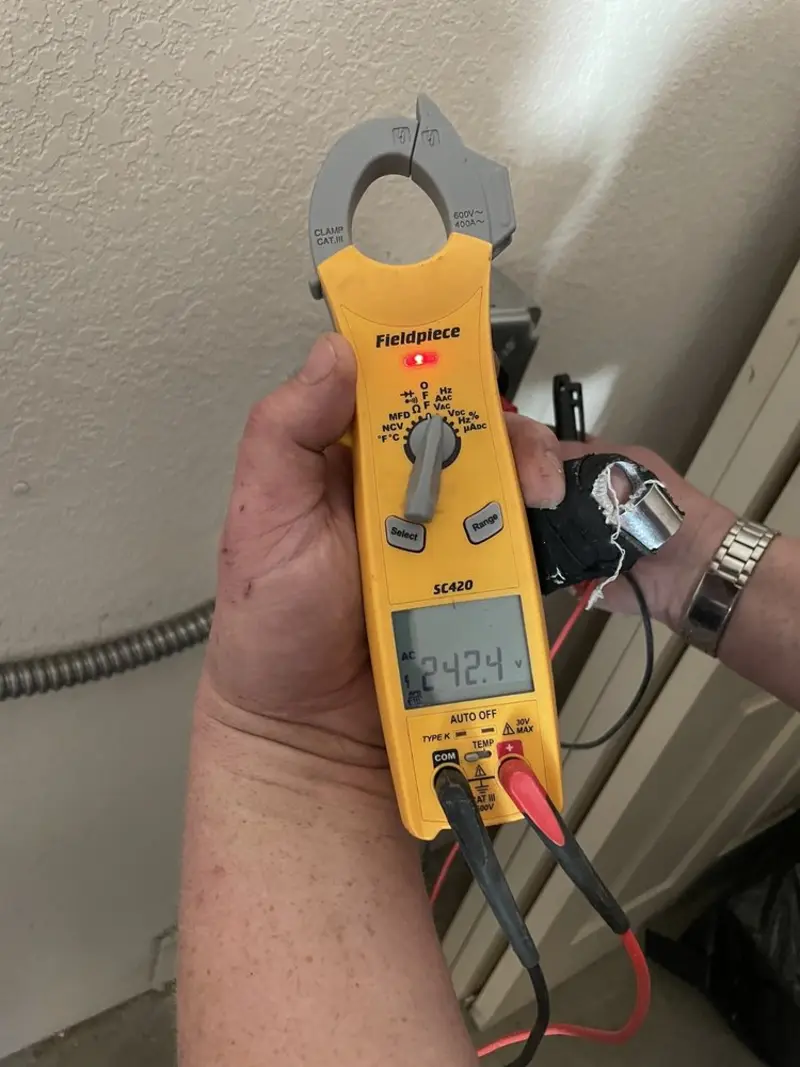 Voltage testing with clamp meter during Recessed Lighting Installation in Essex